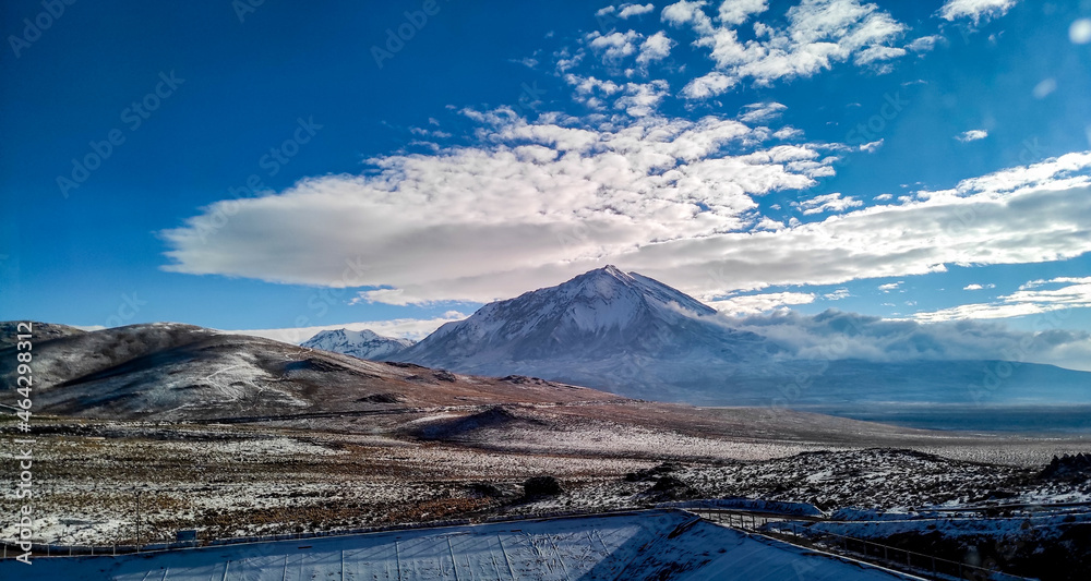 Volcano covered with snow and blue sky 