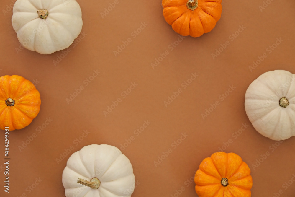 Bunch of decorative mini pumpkins of different kind and color on dark orange background as a symbol of autumnal holidays with a lot of copy space for text. Bunch of decorative mini pumpkins of different kind and color on dark orange background as a symbol of autumnal holidays with a lot of copy space for text.