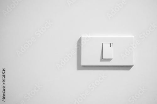 white lighting switch on concrete wall background