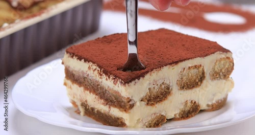 Close up of homemade tiramisu cake. Serving a slice of delicious tiramisu. 4k