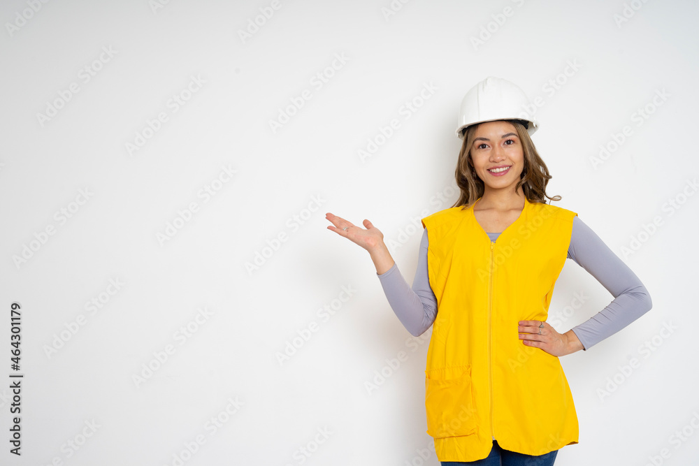 engineer woman smiling to the camera while presenting with hand