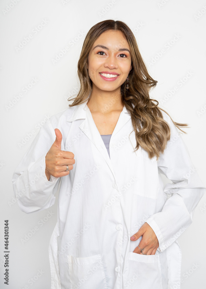 Young doctor woman over isolated background giving a thumbs up gesture