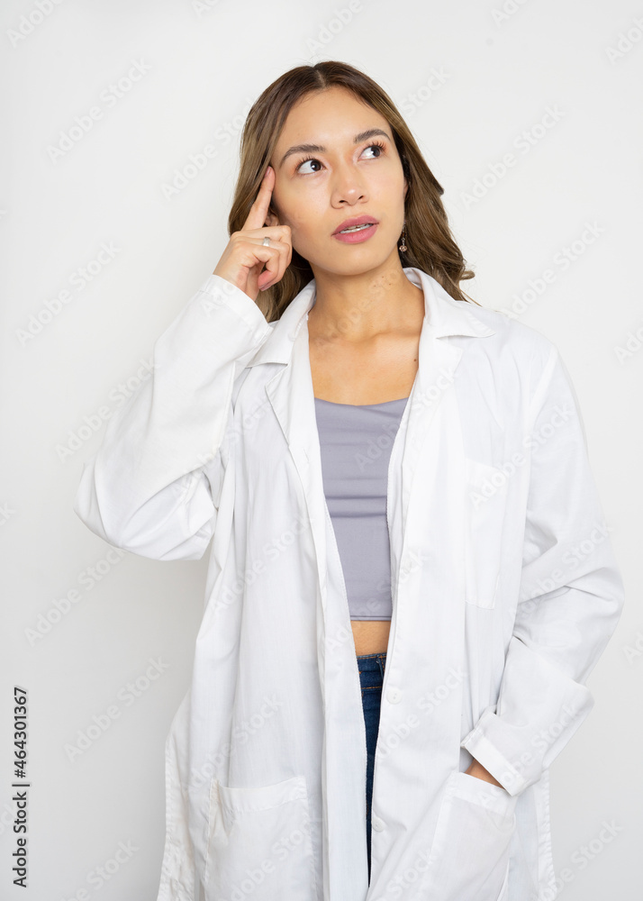 Young doctor woman over isolated background thinking an idea Young doctor woman over isolated background thinking an idea