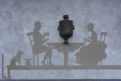 Interesting original  wall decoration: tea drinking  ceremony at the table with a samovar in retro style. Ethnocultural complex Nanosy Novoselje in Belarus photo