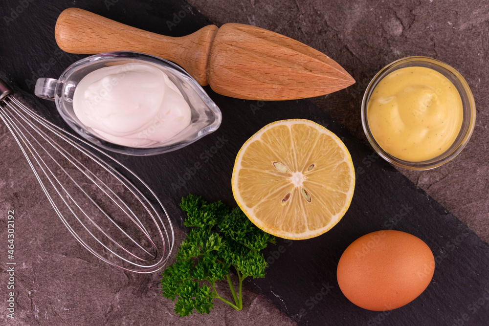 Mayonnaise sauce on a gray background. Ingredients for making mayonnaise sauce. Flat lay. Mayonnaise sauce on a gray background. Ingredients for making mayonnaise sauce. Flat lay.