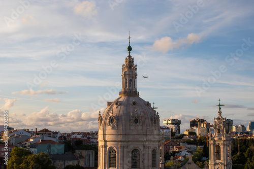 "Basílica da Estrela" dome in Lisbon City with a plane in the sky