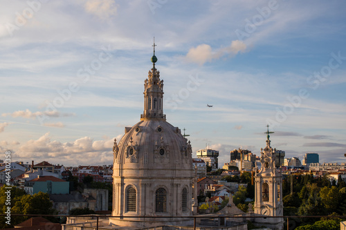 "Basílica da Estrela" dome in Lisbon City with a plane in the sky © André Almeida