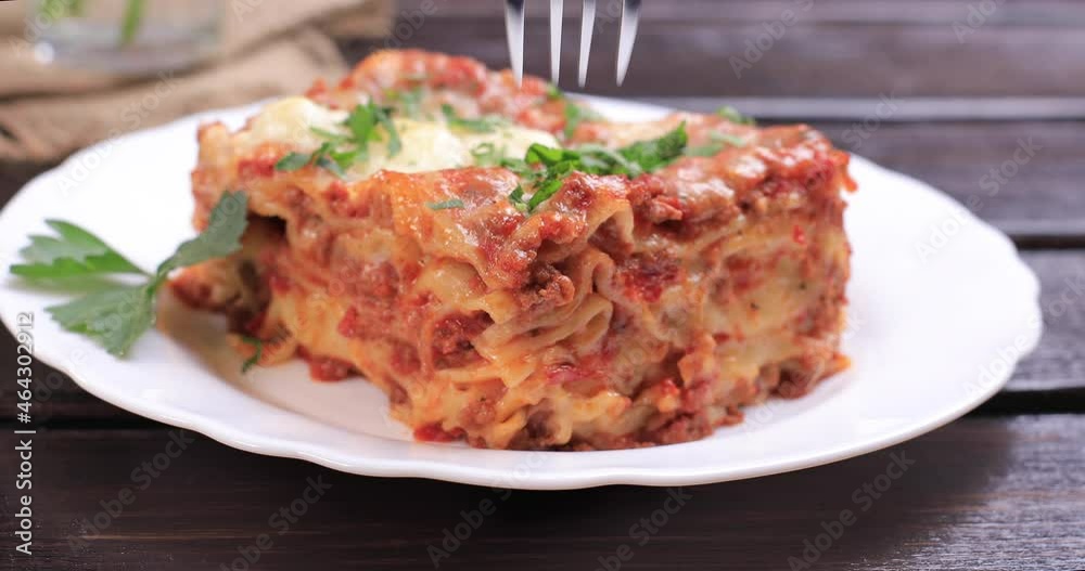 Eating a slice of lasagna italian food pasta. Cooking home concept. Dolly shot 4k Eating a slice of lasagna italian food pasta. Cooking home concept. Dolly shot 4k