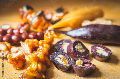 Close up image of Sliced peaces of Churchkhela on the wooden surface and blank space background. Georgian delicacy and traditional dishes in Caucasus. photo