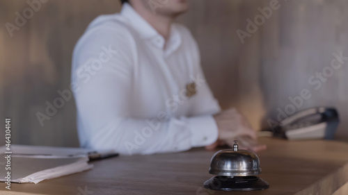 cropped view of hotel receptionist at hotel counter.