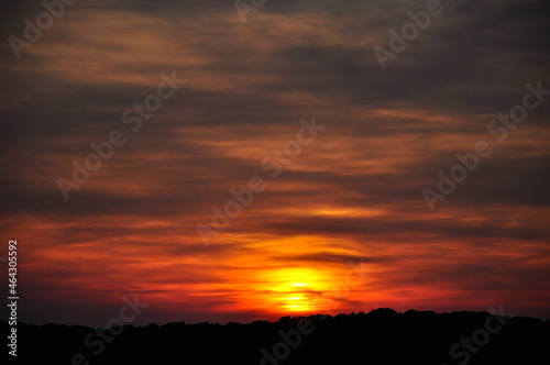 Red sunset sky blow and horizon, nature background.Silhouette sunset with orange sky with clouds at dusk and high space © Marilena