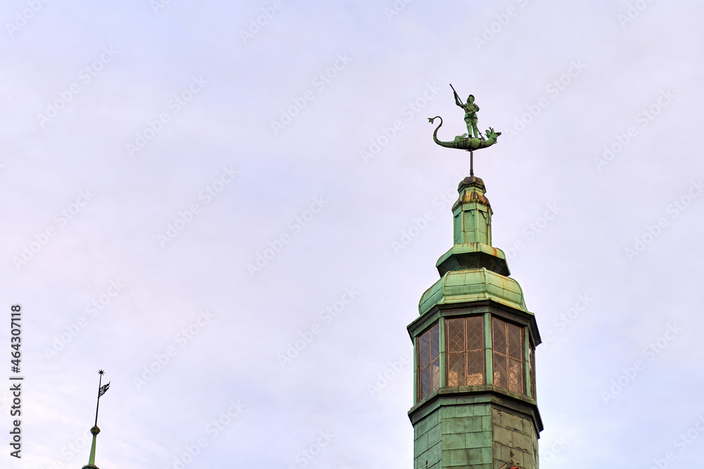 Old St. George weather vane on rooftop in Gdansk, Poland. Architecture detail.