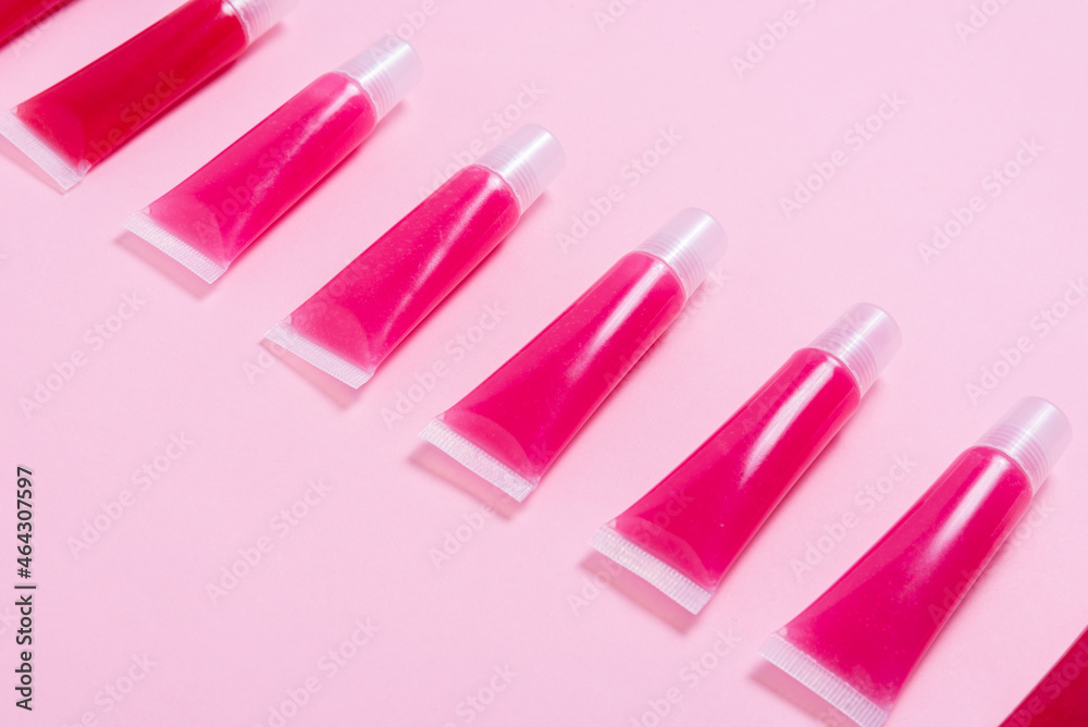 Lot of homemade lip glosses on pink background Lot of homemade lip glosses on pink background