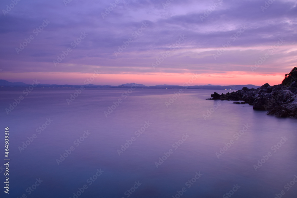 Sunset view at coast of Albania, from Corfu island, Ionian sea, Greece