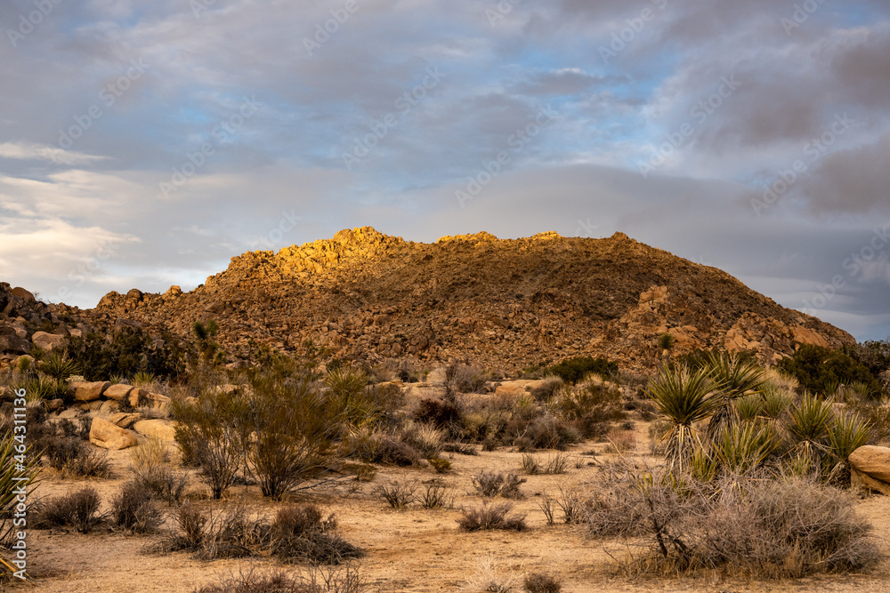 Faint Light On The Top Of A Rocky Hill In Joshua Tree