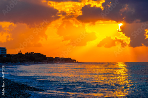 The most beautiful colorful golden sunset Ialysos Beach Rhodes Greece.