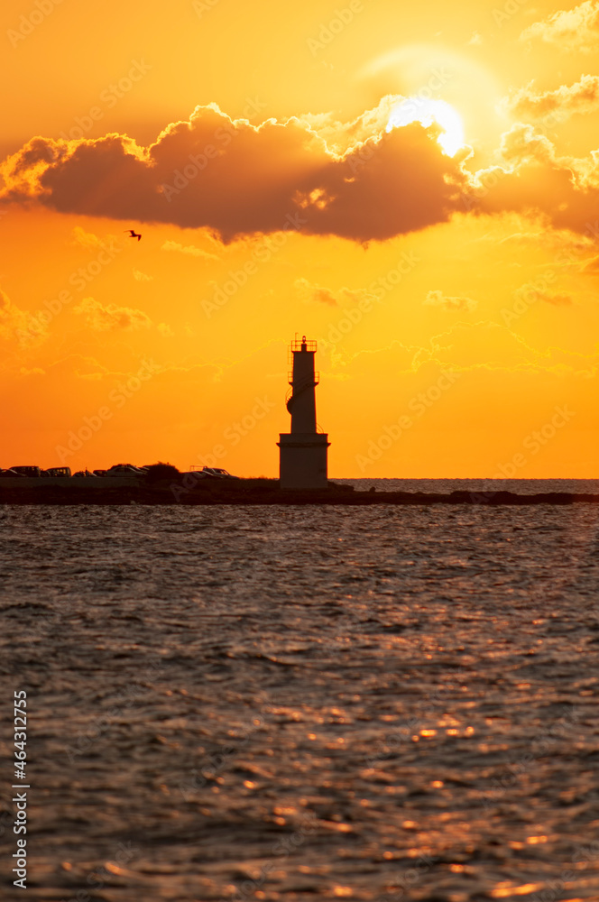 Vertical panoramic view of a lighthouse over the sea at sunset on the island of Formentera in Spain