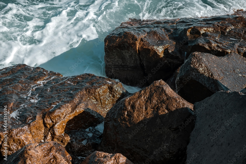 Strengthening the shore from erosion with concrete tetrapods. The seashore with concrete blocks. The element of water. Waves break on concrete. Strengthening the shore from erosion with concrete tetrapods. The seashore with concrete blocks. The element of water. Waves break on concrete.