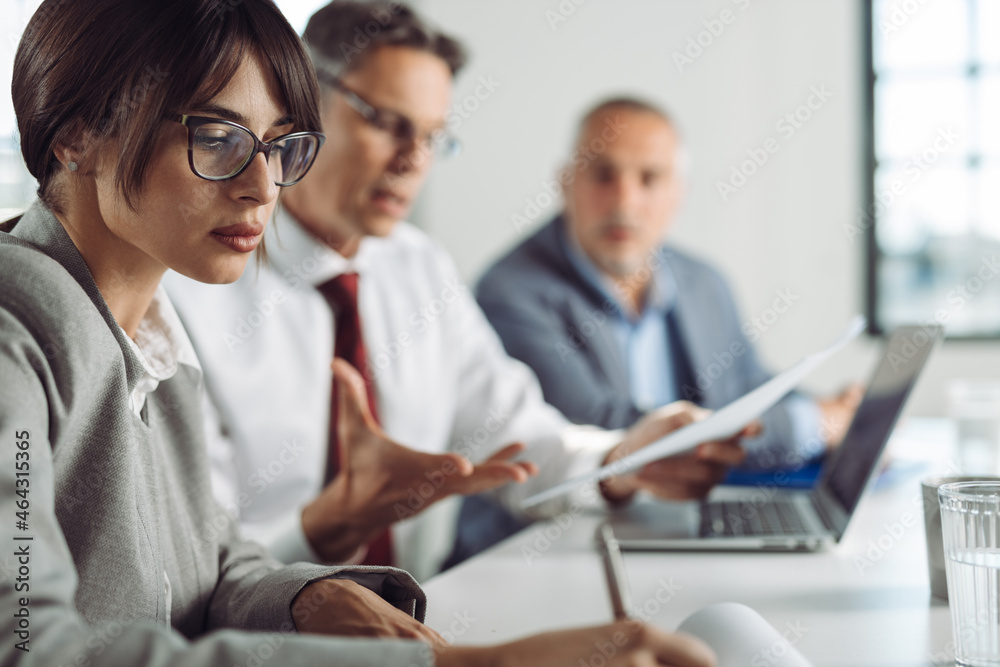 Young businesswoman taking notes on a meeting in the office Young businesswoman taking notes on a meeting in the office