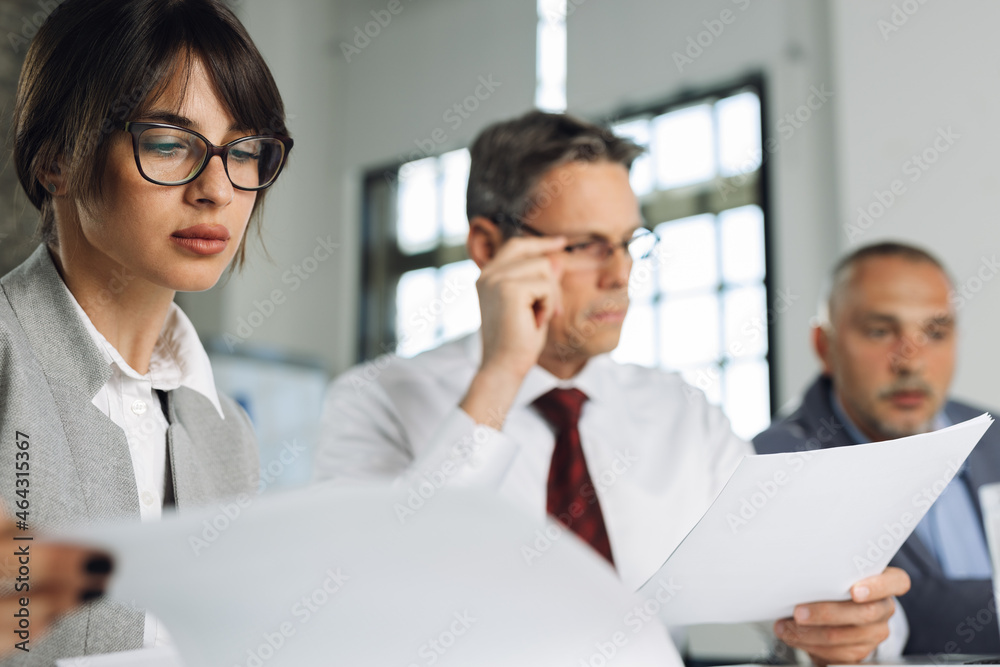 Close up of businesswoman looking at reports on a business meeeting Close up of businesswoman looking at reports on a business meeeting