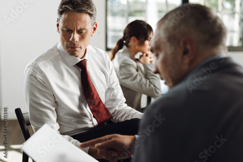  Businessman discussing with his colleague about business reports