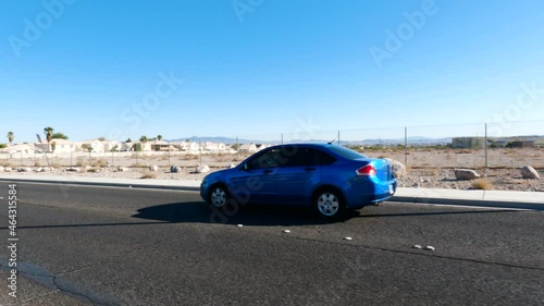 Car Drives Past On Desert Road photo