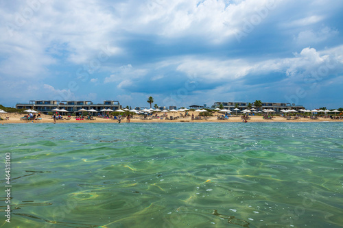 Beautiful colorful view of resort beach on blue sky with white clouds background. Greece. 