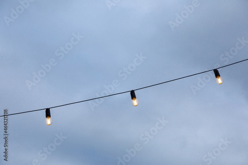 light bulb garlands against the blue sky