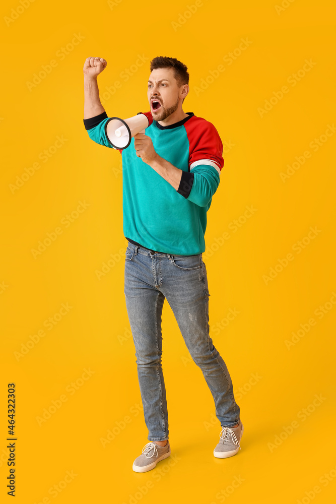 Protesting man with megaphone on color background