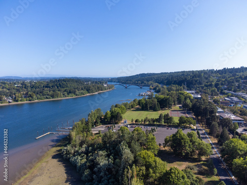 Picturesque landscape - big blue river between two banks. Lots of greenery - trees, bushes. Blue cloudless sky. Tranquil scenes. The beauty of nature. Fishing, recreation, relaxation, tourism.