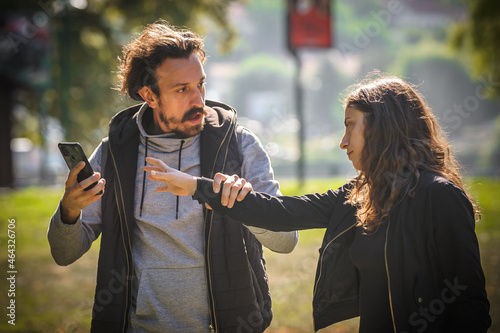 Fototapet Aggressive jealous young boyfriend took his girlfriend mobile phone