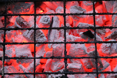 burning charcoal under the grid