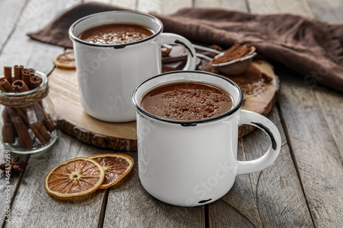 Cups of tasty hot chocolate on wooden background