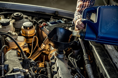 Repairman s male hands with a wrench. Vehicle fitter inspecting used car engine