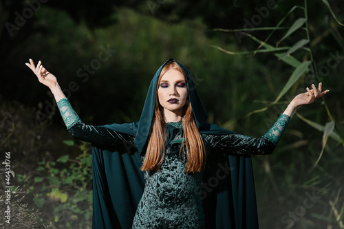 Portrait of young witch outdoors photo
