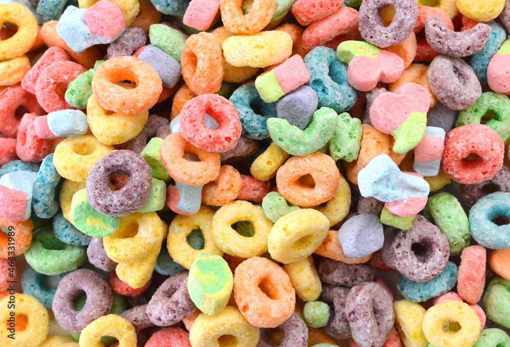 Delicious and nutritious fruit cereal loops flavorful on background, healthy and funny addition to kids breakfast