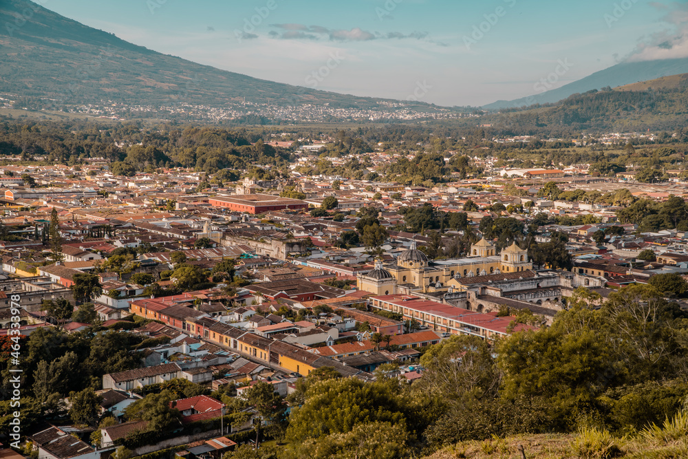 Aerial sunset view of the center of Antigua Guatemala with Iglesia de la Merced and surrounding mountains