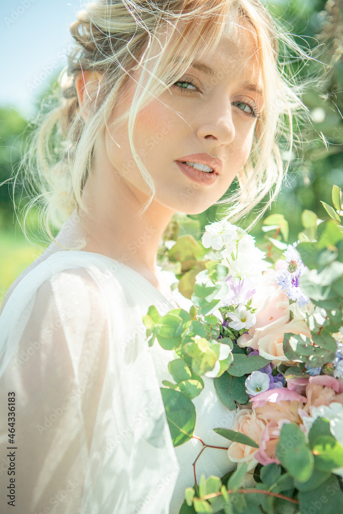 Lovely bride, blonde with a luxurious wedding bouquet. Portrait. Shooting in high key. Lovely bride, blonde with a luxurious wedding bouquet. Portrait. Shooting in high key.