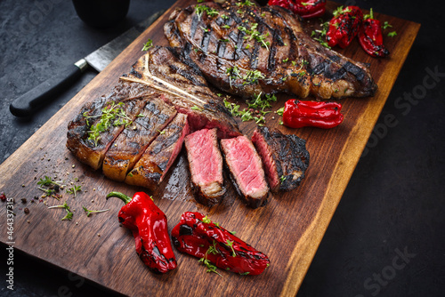 Rustic traditional barbecue dry aged wagyu t-bone and cote de boeuf beef steak with paprika and chili served as to view on a wooden design board