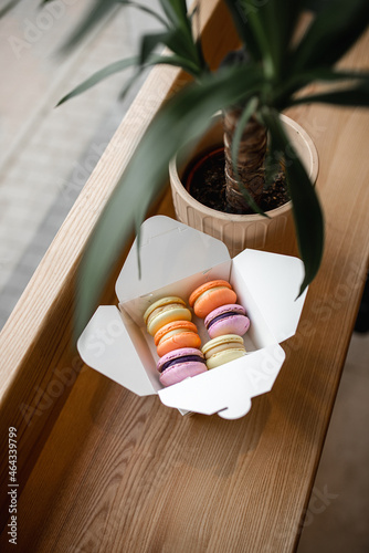 Macaroon cookies in a box on a wooden table