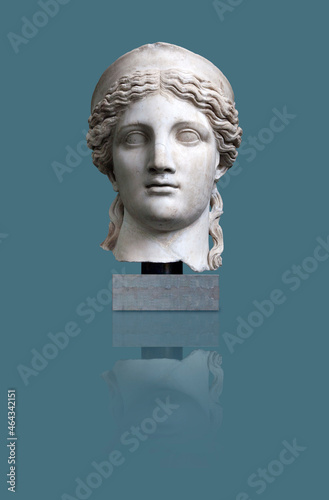 Copy of an antique Roman goddess Juno statue isolated on a blue background. Design element with clipping path photo