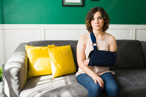 Portrait of an injured woman with an arm sling photo