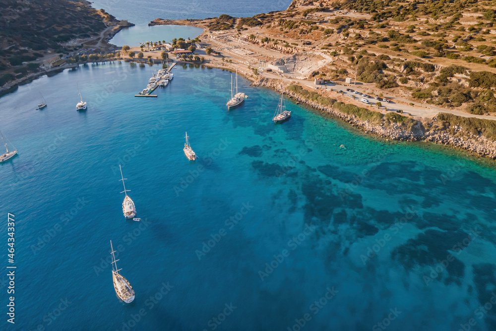 Yachts and sailing boatsin bay with a turquoise and transparent sea. Top view of the sailing boats in blue lagoon