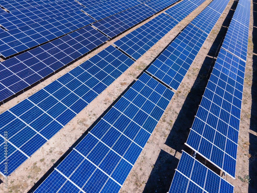 Solar power station with panels standing in rows. Concept of green renewable energy, future technology and innovations Solar power station with panels standing in rows. Concept of green renewable energy, future technology and innovations