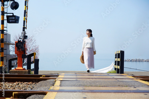 踏切を渡る女性 ,日本,大阪府,泉南市周辺 photo