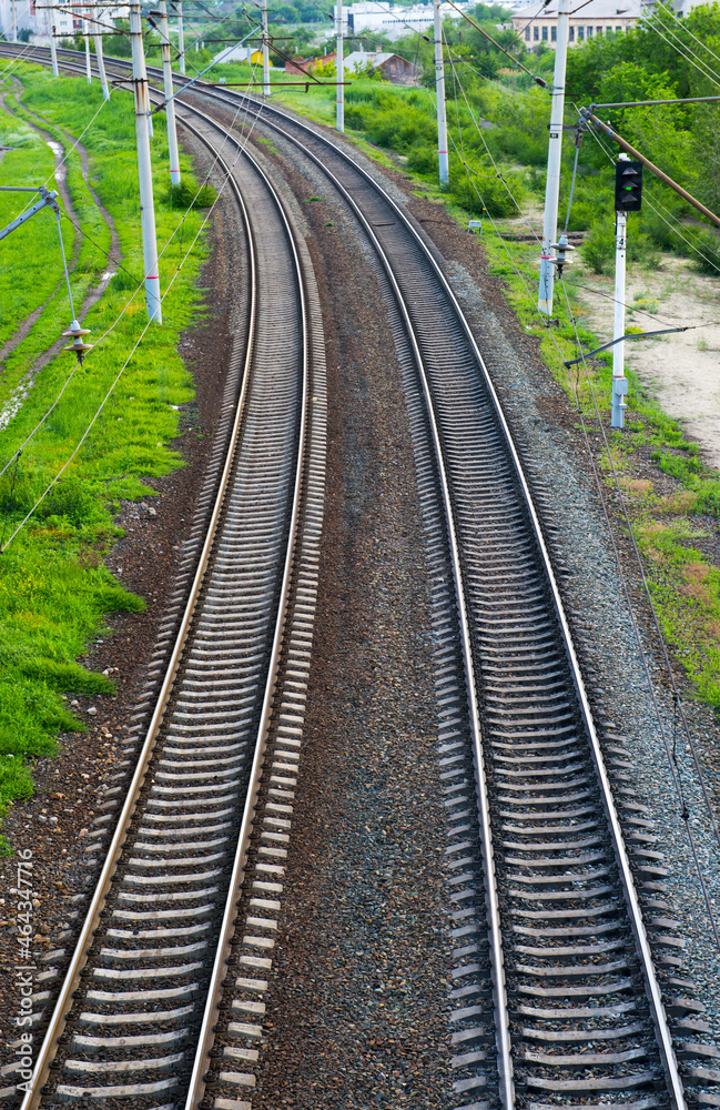 Parallel railway tracks recede into the distance