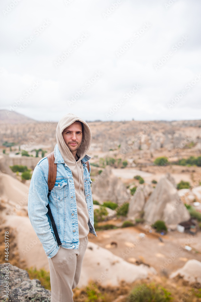Tourist man outdoor on edge of cliff seashore Tourist man outdoor on edge of cliff seashore