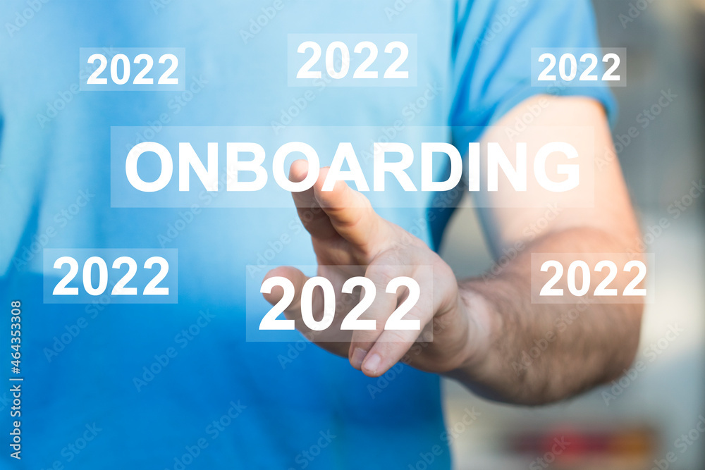 Businessman presses button onboarding process 2022 year business on virtual panel. Businessman presses button onboarding process 2022 year business on virtual panel.