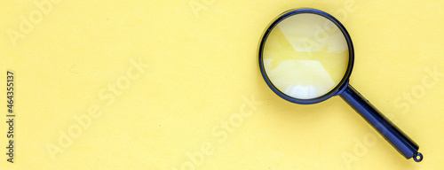 close up magnifier glass on yellow background