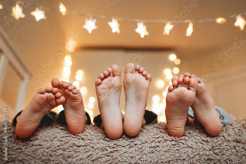children's feet on the background of a Christmas garland
